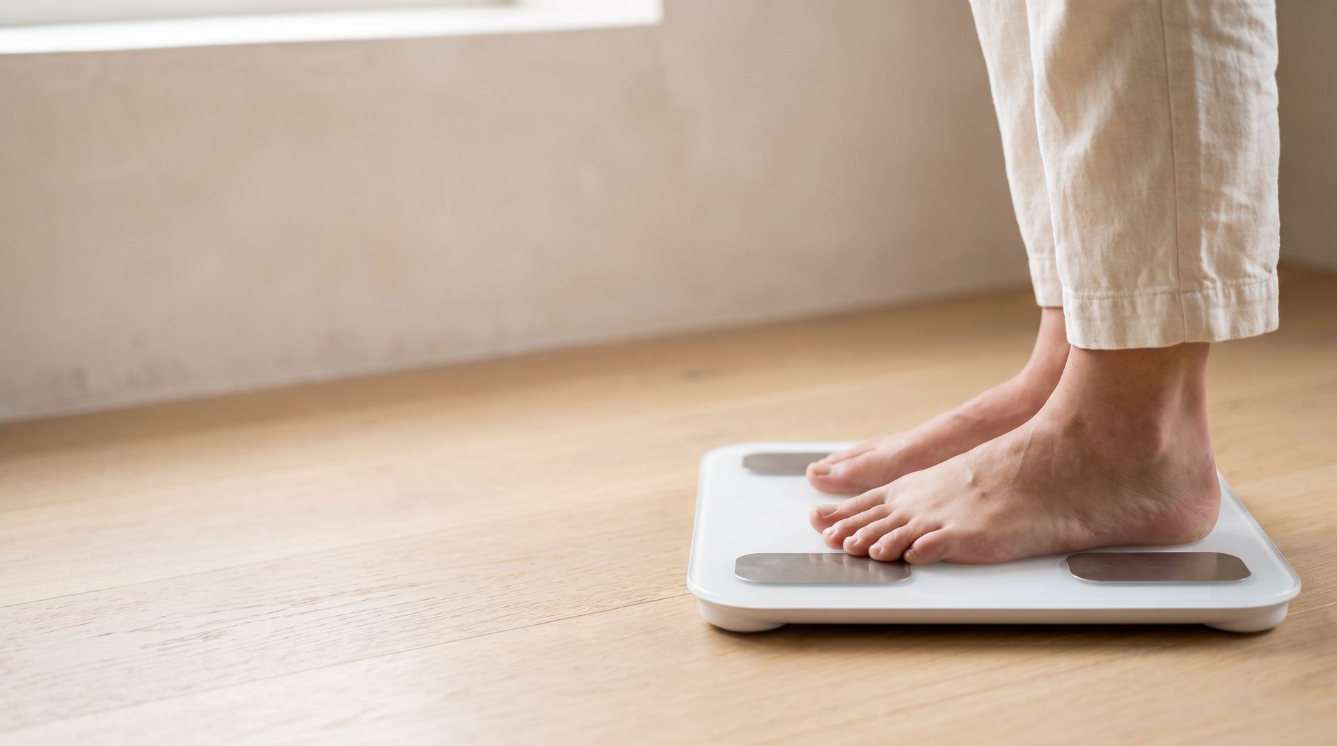 Bare feet standing on a body composition scale